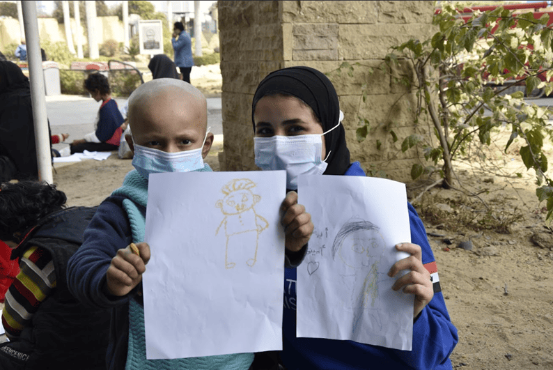An Eco Racing Team member displaying the artwork created by a child An Eco Racing Team member displaying the artwork created by a child from 57357 during our visit.